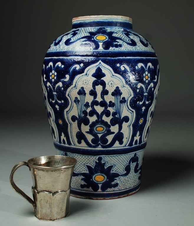 A large and impressive early 20th century talavera Poblana blue on white jarron by Isauro Uriarte - Fabrica de la Loza de Talavera, one of Mexico's most important talavera studios. The silver cup is shown for scale only and is not part of this