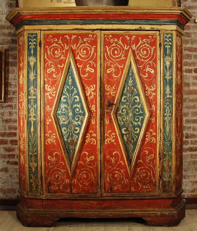 A fine 17th century Tuscan armadio, painted in arabesques with large raised panel doors, painted cornice and bracket feet. Original hardware and working lock.<br />
<br />
Dimensions: 85.5 inches high x 78.5 inches wide x 26.5 inches deep.<br