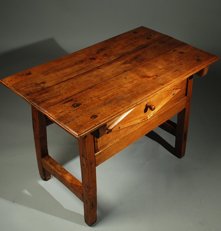 A good early 19th century Mexican table in Spanish cedar with large square head nails, suspended drawer and splayed legs connected by a stretcher base. Overall with warm, honey colored patina. <br />
<br />
Dimensions: 39 inches long x 23 inches