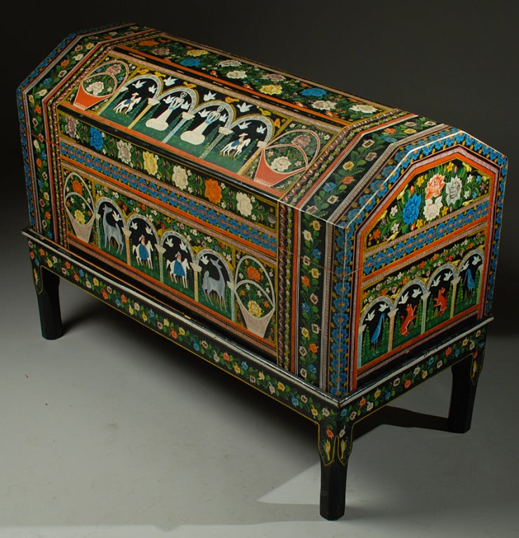 This striking mid century Mexican lacquer baul from Olinala is painted all over in elaborate detail with colorful flower baskets, playful animals and equestrian scenes surrounded by swirls of foliate motifs and graphic foliate borders. The overall