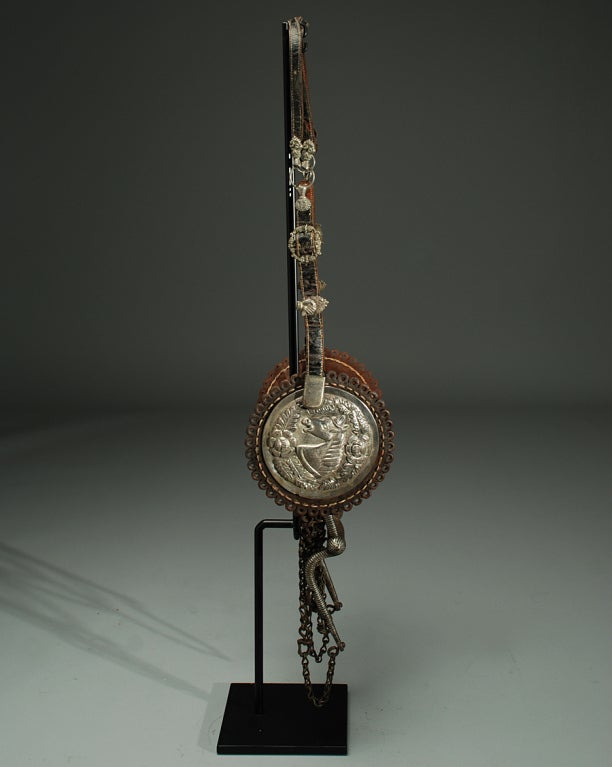 A stunning mid 19th century Mexican horse bridle with large and impressive silver repousse conchos, silver inlaid bit, silver milagros, buckles and clasps. Beautiful hand stitched leather original curb chains - circa 1850. 

Dimensions: overall