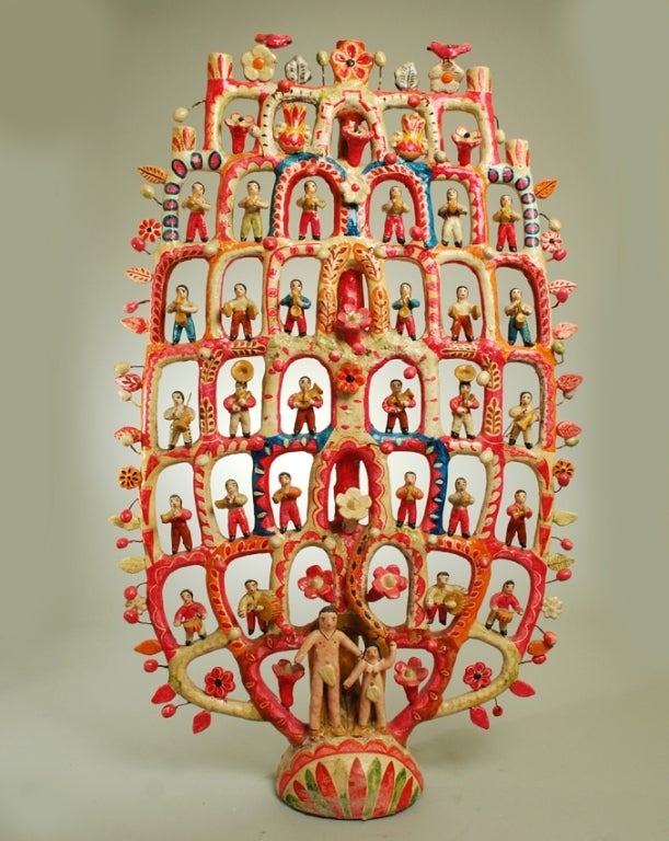 A large and impressive vintage Mexican ceramic tree of life candelabra with Adam and Eve surmounted by multiple rows of dancers and musicians. Overall with excellent color and surface patina. Circa 1950.

Dimensions: 41.5 inches high.

In