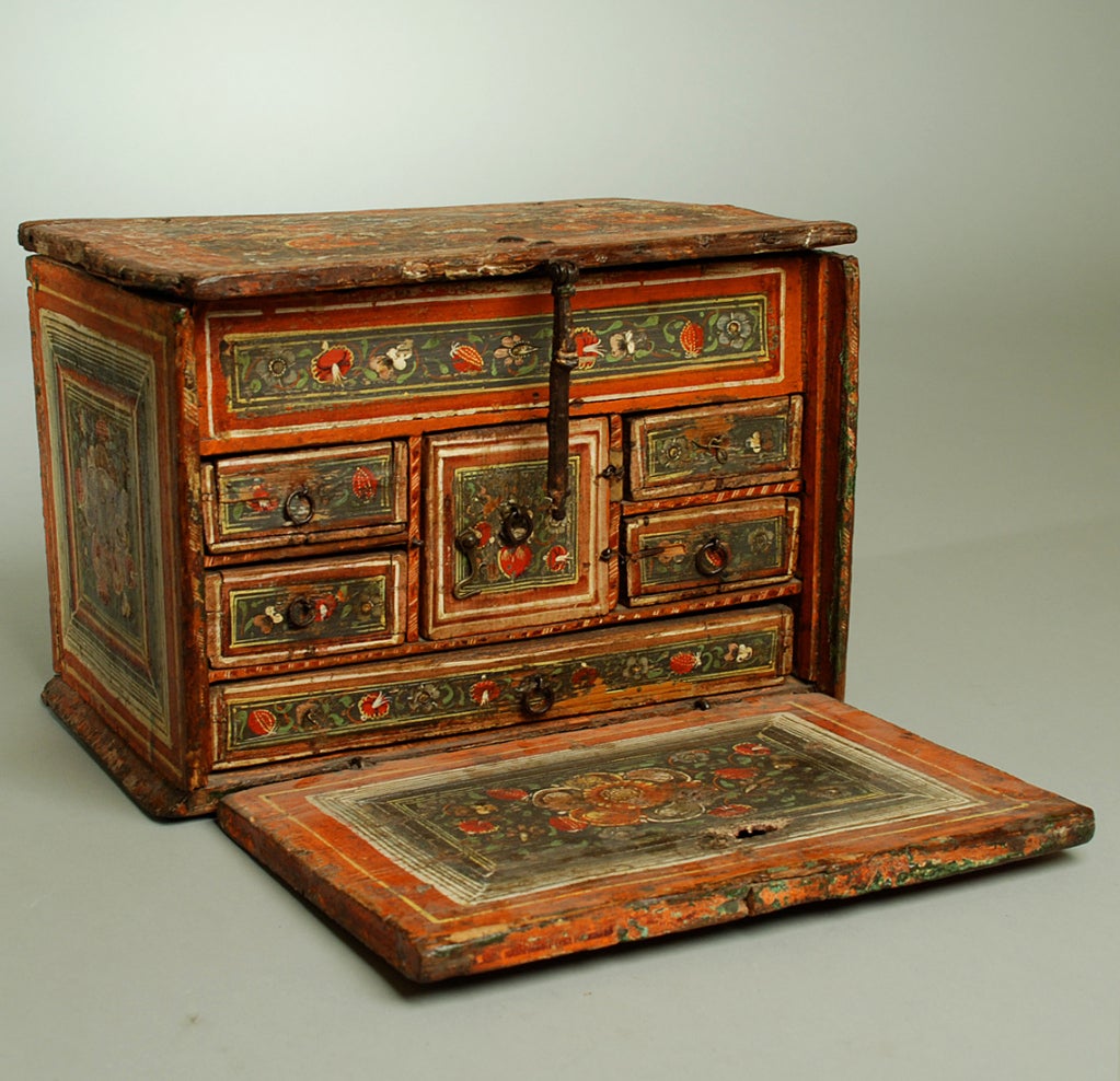 This 18th century papelera (document / writing box) from Michoacan, circa 1750, is a colonial masterpiece of the highest caliber - made by hand in the time honored tradition with the original wrought iron strapping, lock-plate, hand painted and hand