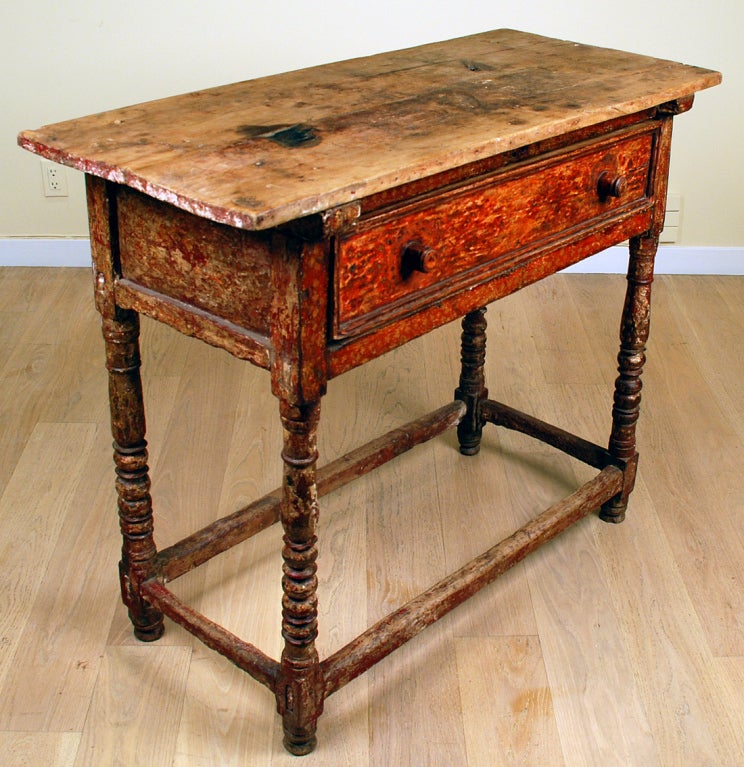 A rare 17th century Spanish colonial painted table from Peru with single drawer supported by turned legs and connected by a stretcher base. Overall with excellent wear and patina. Sabino wood top with diamond cut dowels and old candle burns.