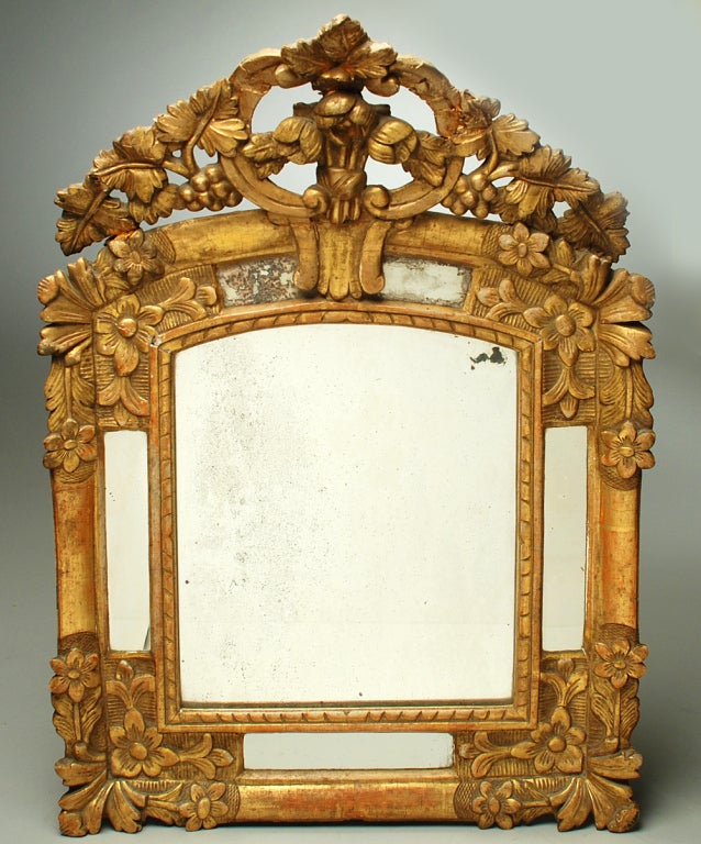 A classic 18th century Italian Baroque gilt-wood mirror with excellent wear and surface patina - circa 1780.

Dimensions: 24.5 inches vertical x 17.5 inches horizontal.

Condition: several old repairs to crown.