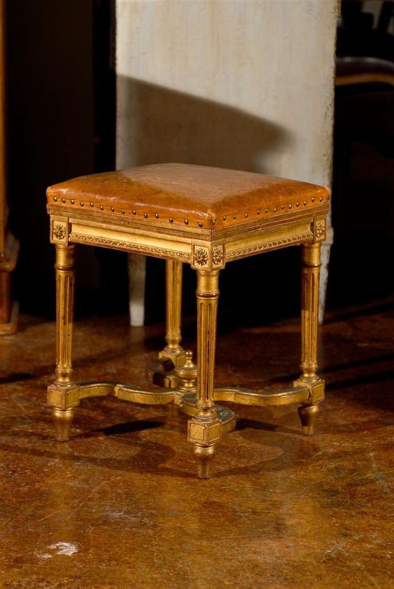 French giltwood bench with leather top.