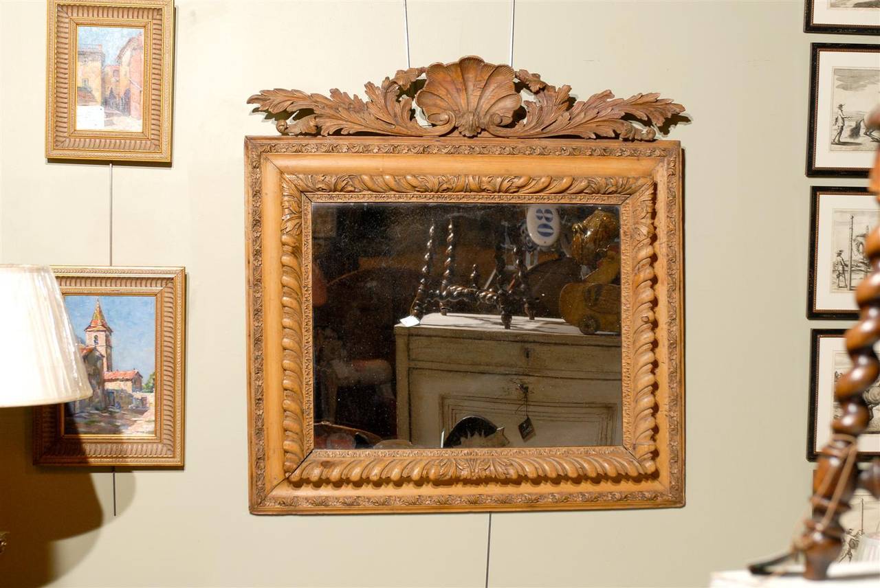 19th century George II style giltwood mirror, the clamshell and leaf crest surmounting a rectangular mirror with foliage theme borders.
