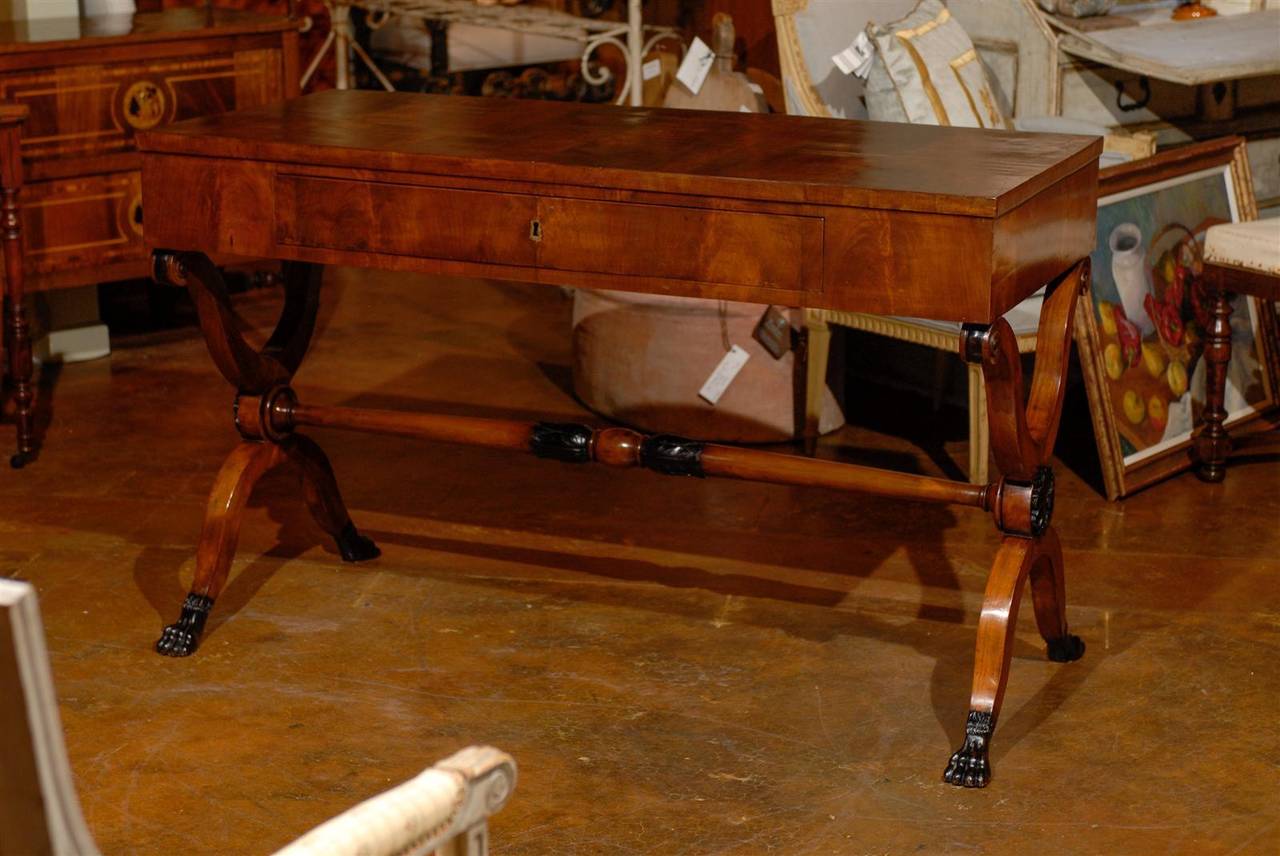 Italian walnut desk with carved stretcher and paw feet. One drawer with key.