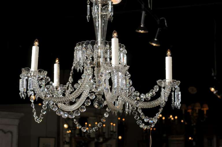A Belgian crystal unusual shape five-light chandelier from the 19th century. Born in Belgium, this crystal chandelier features a central metal armature surrounded by flared ornaments and cups, and adorned with icicle-shaped crystals. Pointing down