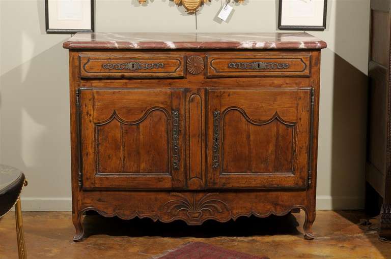 An 18th C. Louis XV Provincial fruitwood or beech buffet with faux marble top above two shaped channeled frieze drawers, over a pair of shaped paneled doors, on squat cabriole supports.