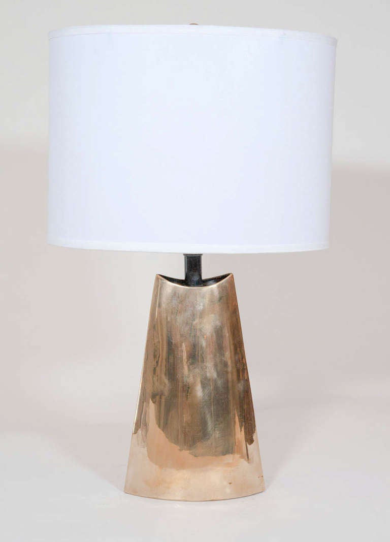 A simple sculptural brass lamp.
With great patina and form.
New oval shade optional.