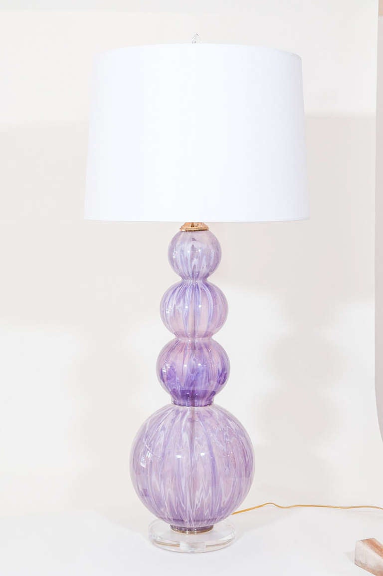 A large funky glass ball lamp with a new clear glass base has a striking look for any glamorous room. Paper shade available.