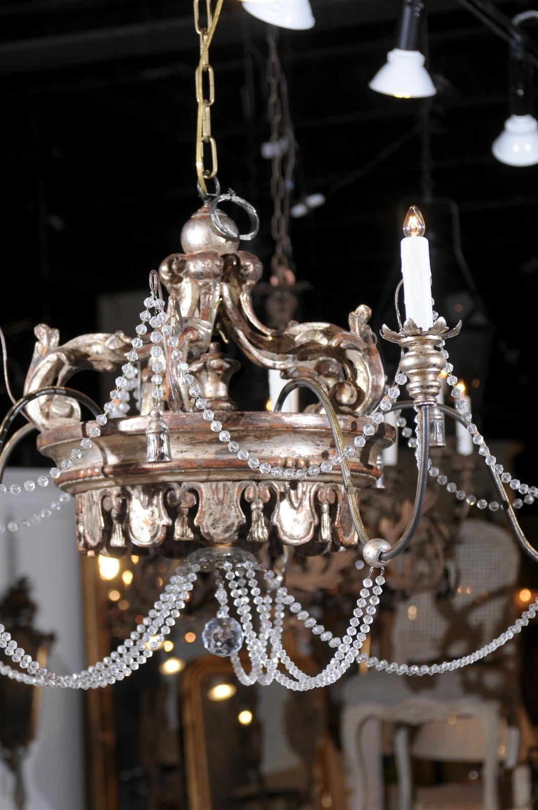 Italian silvergilt crown chandelier with crystal swags and five arms.