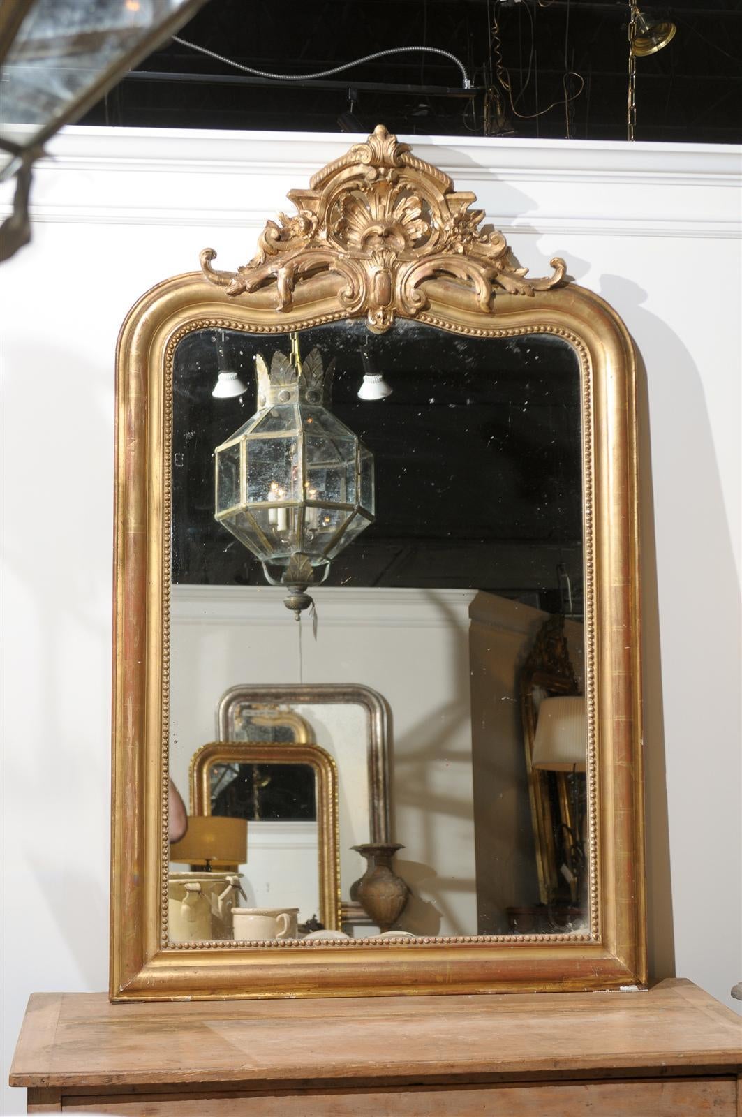 French giltwood mirror with crest and original mirror.