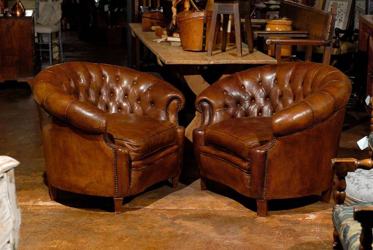 Pair of French Chesterfield leather chairs.