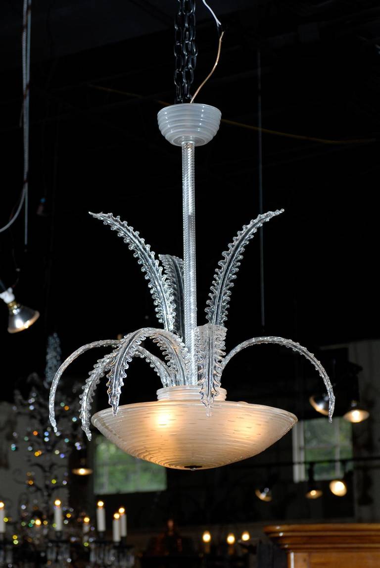 Contemporary glass chandelier, with an inverted bowl form central support from which two rows of fern leaves abound.