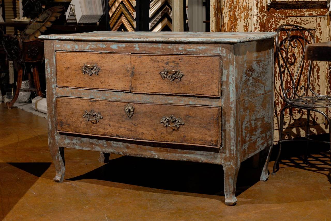 18th century French paint decorated commode, the shaped rectangular top surmounting two short and one long drawer, raised on sabre legs, found in Toulouse, France.