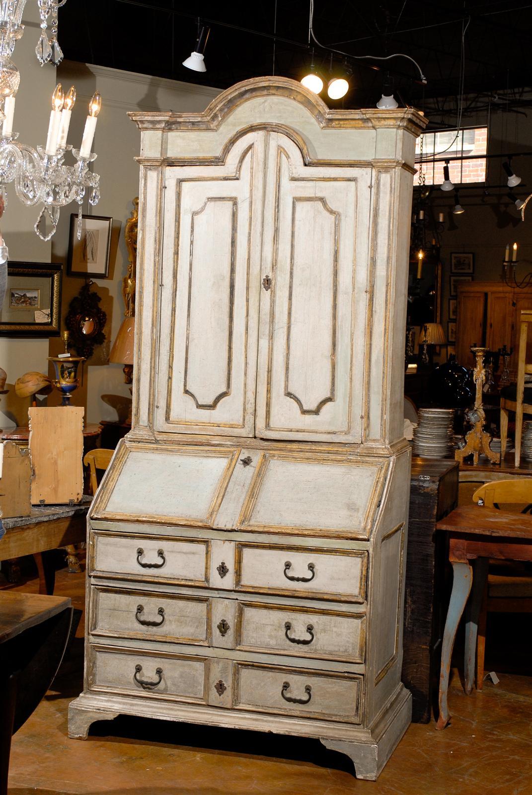 18th century Italian paint decorated drop-front secretaire, the shaped rectangular top surmounting two long doors opening to reveal three shelves above a fall front writing surface opening to reveal two rows of three small drawers, all above a three