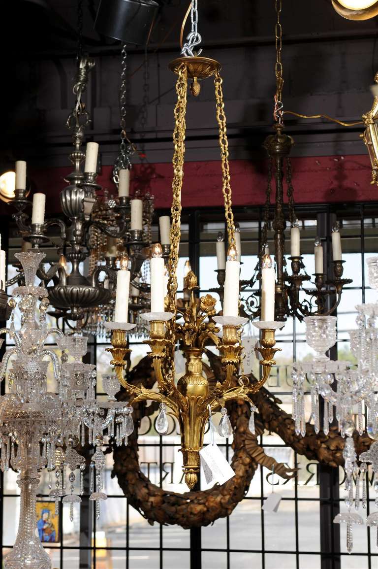Superb gilt bronze chandelier with exquisite workmanship, fine attention to detail, featuring rock crystal pendalogues and bobeches, six lights.