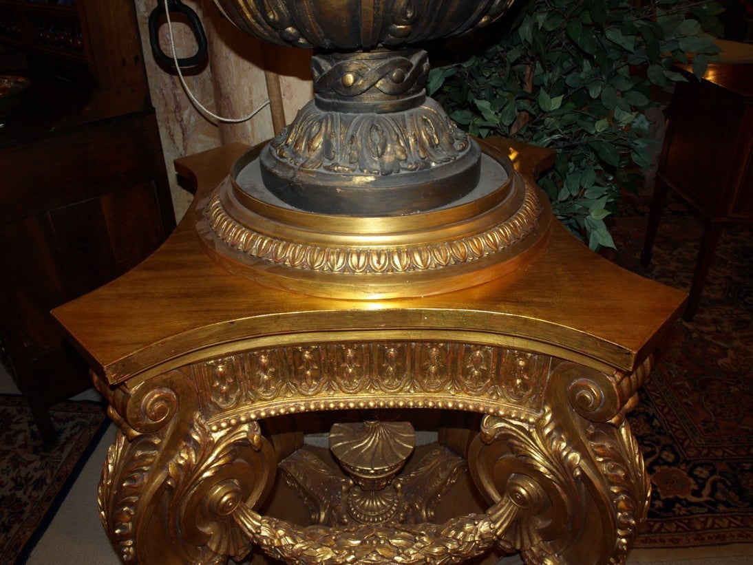 Pair of opulent hand carved giltwood pedestals. The round part on top is removable, it is a stand for a statue, etc.