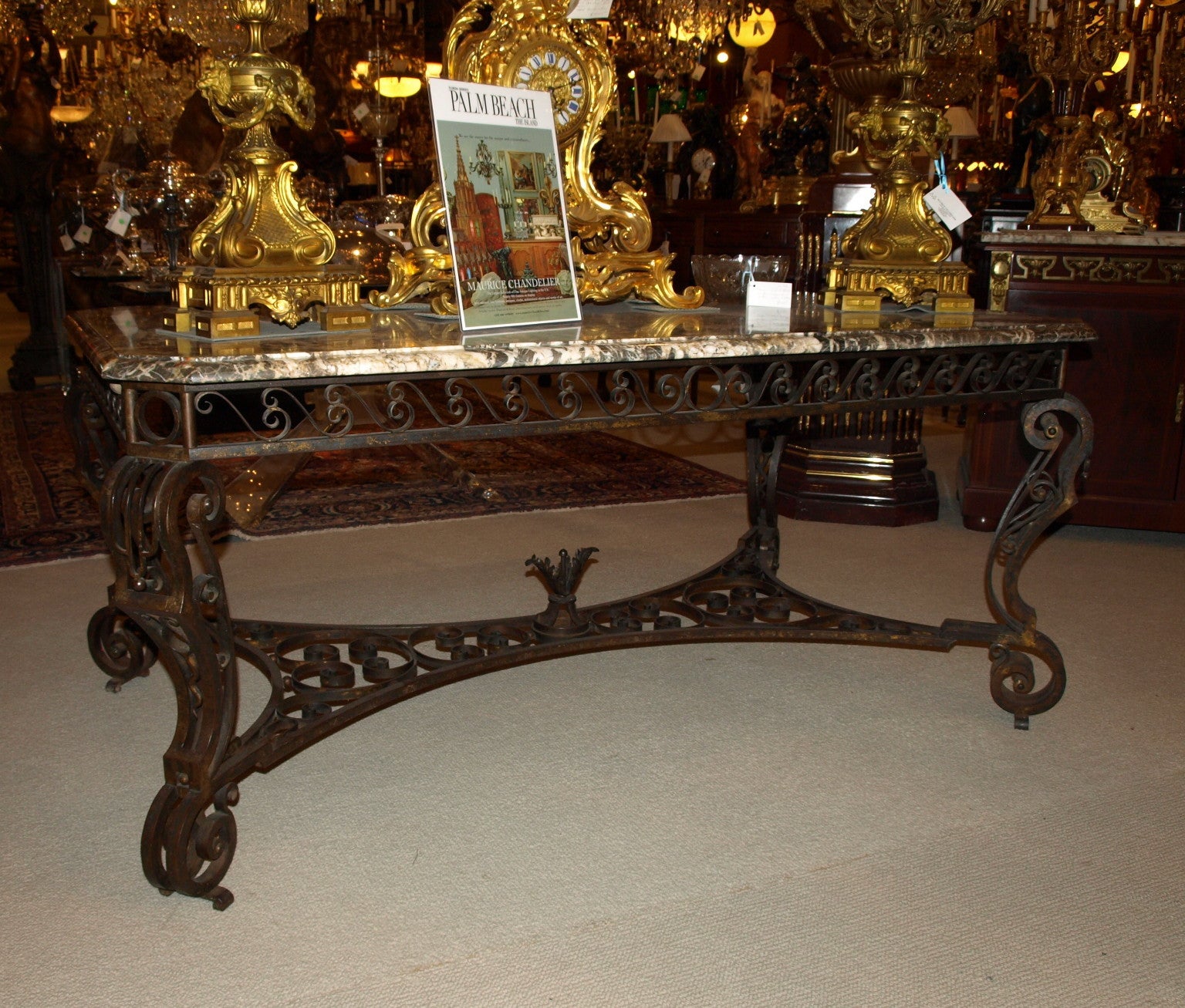 Unusual and beautiful iron table with a beveled marble top and amazing stretcher, could be used as a center table or library table.