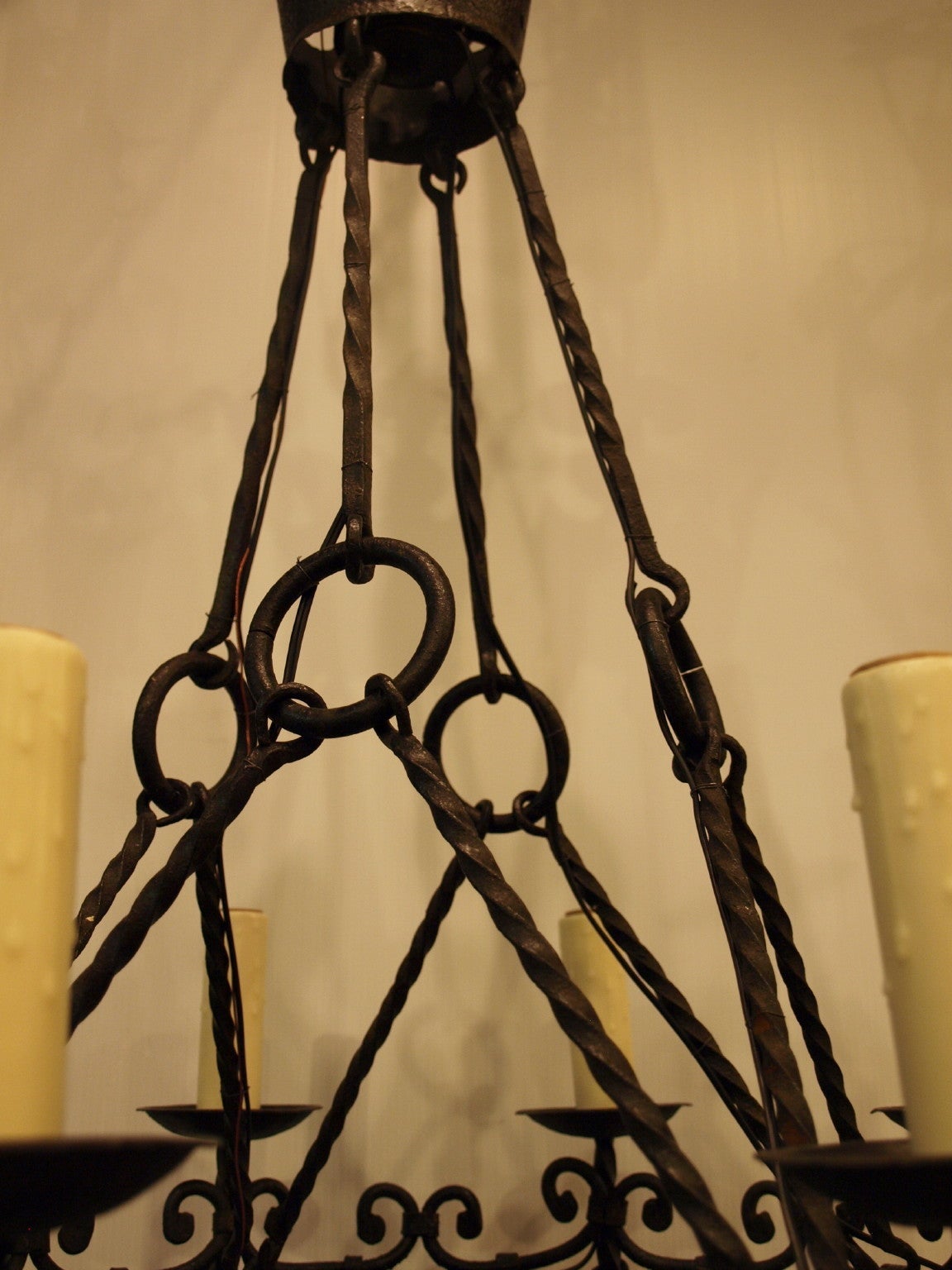 Originally for candles, this elegant eight-light 19th century French iron chandelier has been electrified.