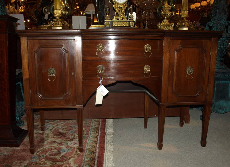 Very fine mahogany sideboard with brass lion head pulls. Has water ring on top.