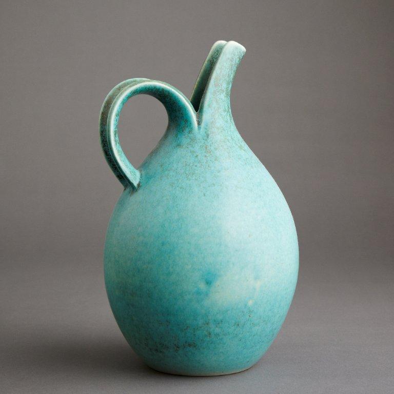 Saxbo turqoise blue pitcher with spout and handle.