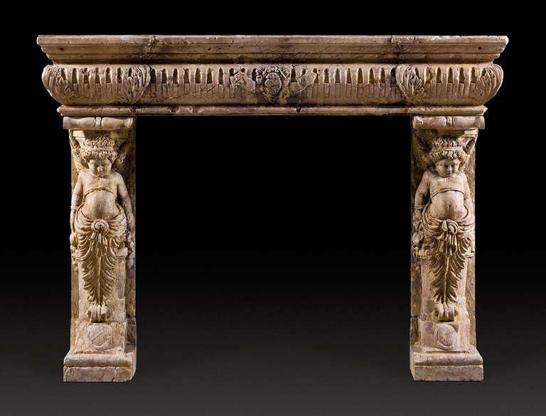 The jambs in the form of Caryatid Armonini with bowed heads, wearing acanthus styled robes. The frieze which protrudes over their heads has cable filled flutes and acanthus at the corners, the central motif is a coat of arms. 19th Century Italian.