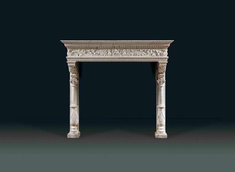 An Italian, Venetian, chimneypiece of Renaissance style in statuary and veined Carrara marbles, 19th century.
The wide tiered shelf with egg and dart and dentil decoration. The continuous shelf of statuary marble decorated at the middle with a