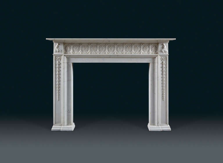 Antique neoclassical fireplace mantle with plain shelf, the frieze with eleven anthemion sprays in circular medallions flanked by protruding blocks carved with figures. The pilaster jambs with inset panels carved with graduating, inverted flower