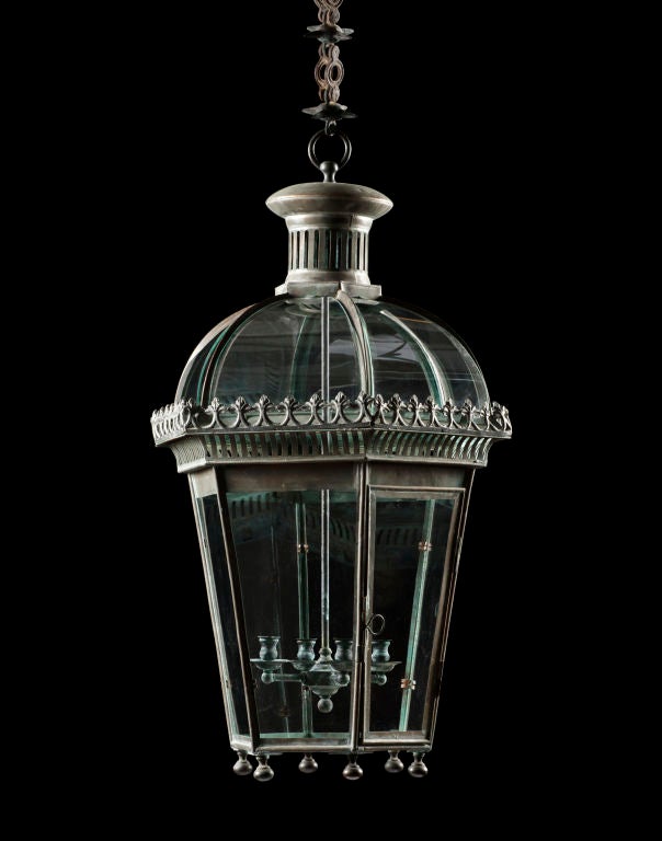 The graceful arched and glazed top with the petal shaped smoke outlet above the pierced filigree work and tapered sides makes this lantern both elegant and functional.