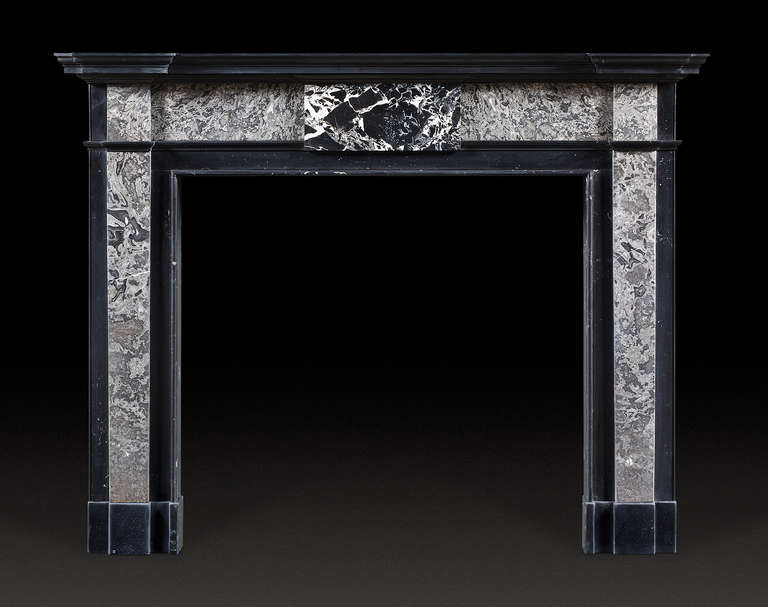 The variegated black and white tablet flanked by grey marble frieze panels above confirming jambs.