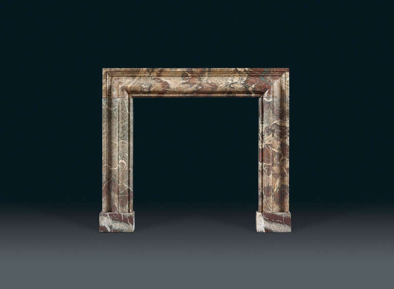 A 19th century, Campana marble bolection chimneypiece of delightful variegated color with impressive ogee mouldings, framed with rectangular, squared mouldings. This highly prized marble was discovered by the ancient Romans in Espiadel, Campana in