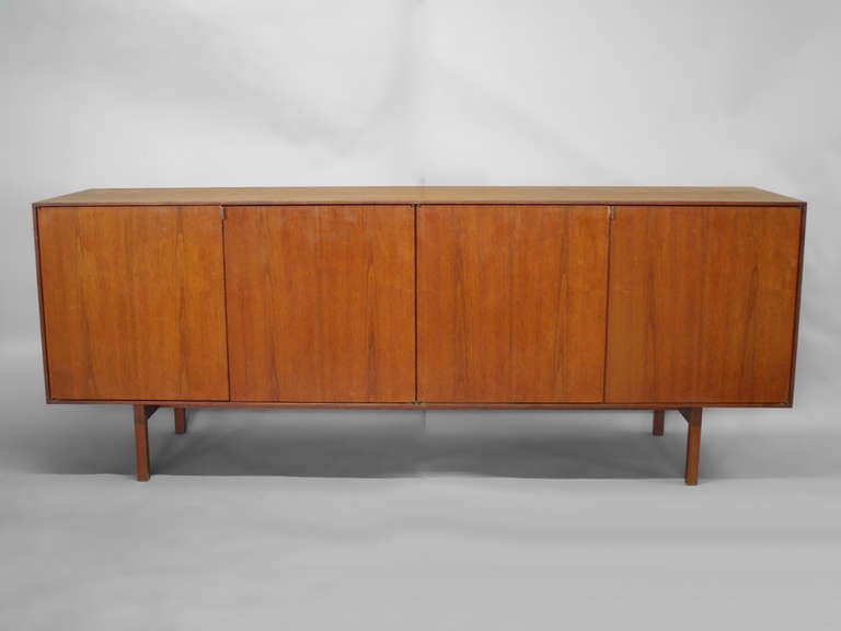 Four-door teak credenza with adjustable shelves by Florence Knoll for Knoll International. Nicely refinished .