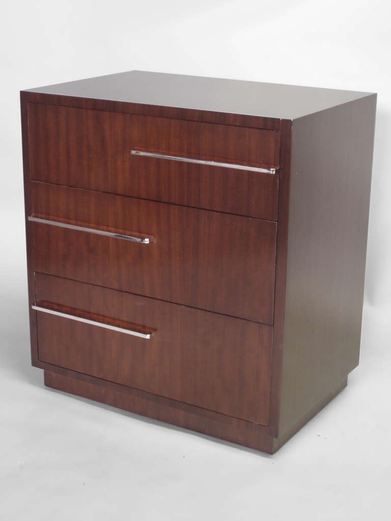  Art Deco Moderne cabinet in the style of Donald Deskey . Three drawer Walnut cabinet with asymetrically placed horizontal chrome drawer pulls . Ever useful and easily placed smaller chest . 