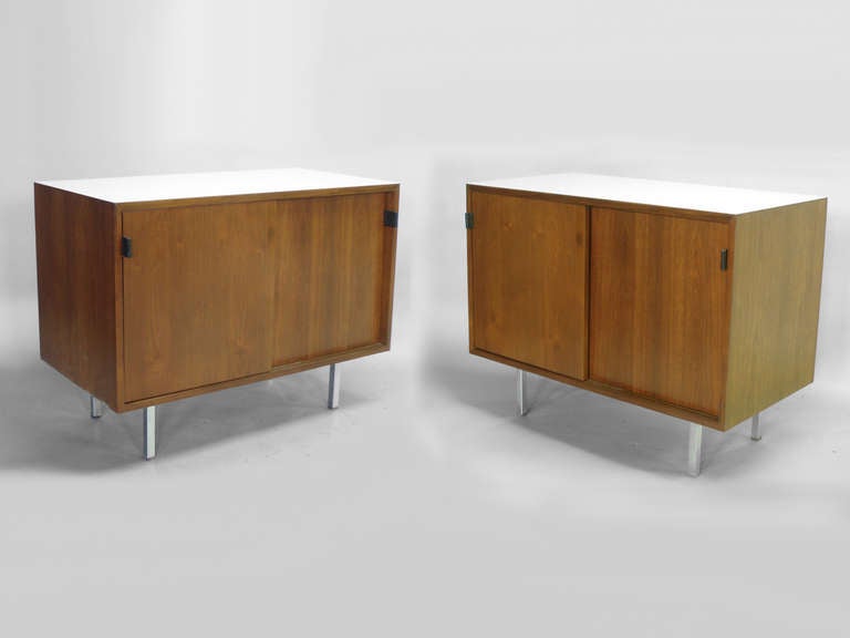 Pair of white laminate top leather pull walnut cabinets by Florence Knoll for Knoll.