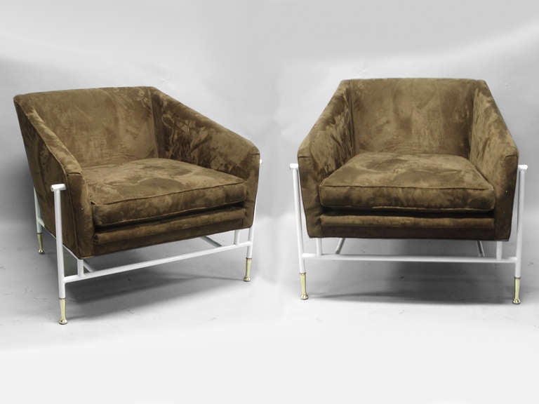Pair of lounge chairs covered in coffee brown ultra sued textile mounted in white powder coated steel frame with polished brass embellishment . In the style or manner of Tommi Parzinger or Gio Ponti .