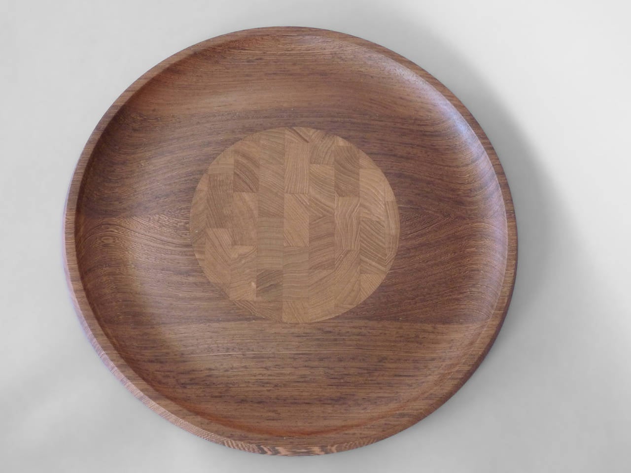 Finely crafted rosewood and teak reversible serving tray by Jens Quistgaard for Dansk.One side in exotic wood grain is smooth and concave to the center . Flip side holds butcher block style center with surrounding concave galley .