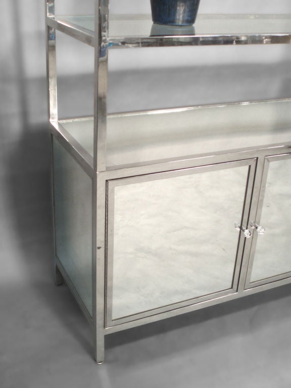 Large polished stainless frame mirror door ètagerè, probably pace, Lucite finials, glass shelves.