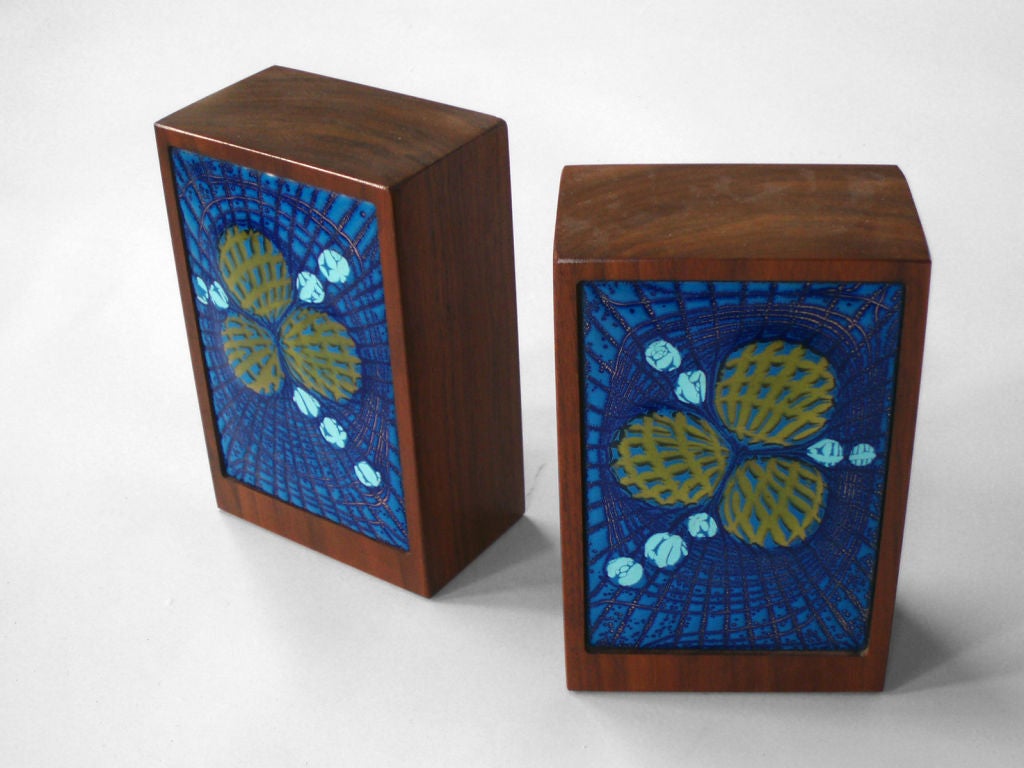 Beautifully enameled copper pieces mounted in walnut bookends. Marked what looks like AD on cork underpass.