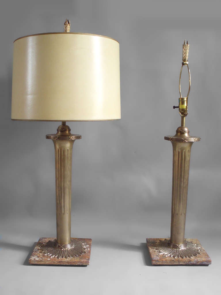 Pair of torch theme bronze on marble table lamps by The Chapman Company (shades not included).