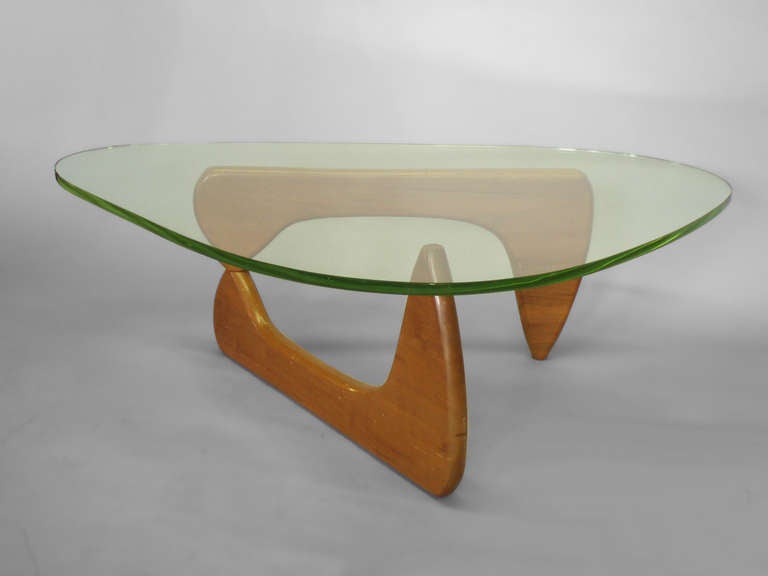 Isamu Noguchi for Herman Miller . Iconic minimalist mid century coffee table . Early green glass top has normal and expected wear . Base appears to be older refinish as original .