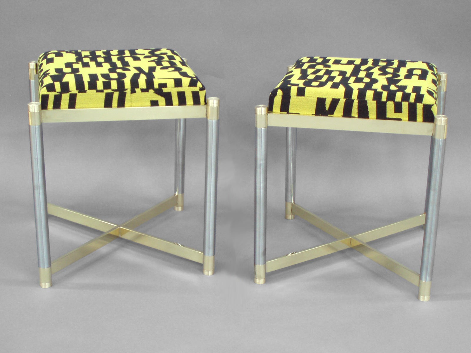 Pair of Brass with Steel Stools by the Weiman Co. Upholstered in letters textile For Sale