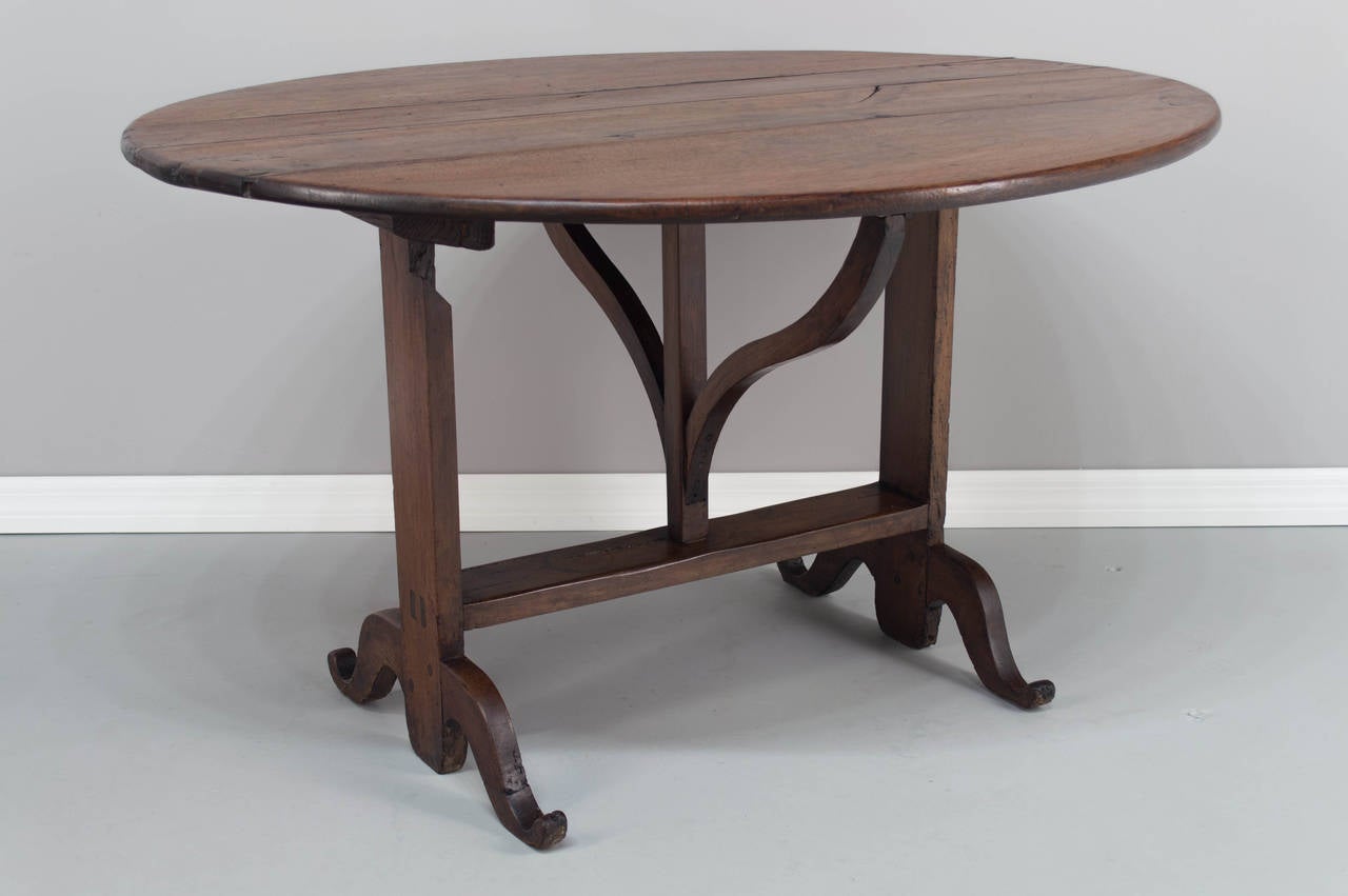 A 19th Century French wine tasting or tilt top table, made of walnut. Top is comprised of four planks, pegged construction, waxed finish. Good and sturdy. 48