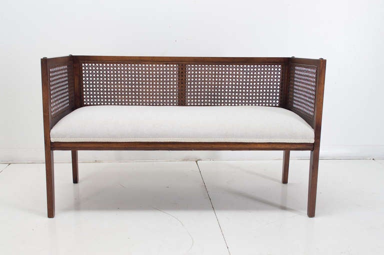 Nice Mid-Century settee with caned back and sides. In original walnut finish, newly upholstered in linen.