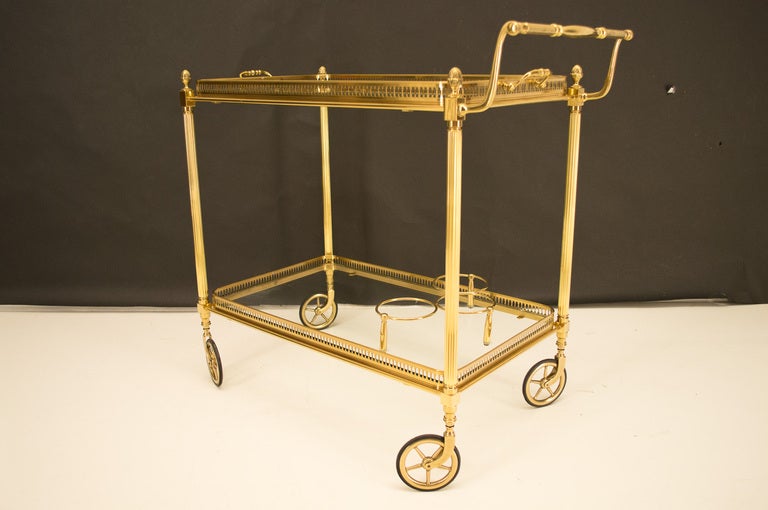 A good bar cart with original glass with the upper tray removable and the lower shelf has a three bottles holder. The cart maneuver quite well with the brass wheels with rubber tire