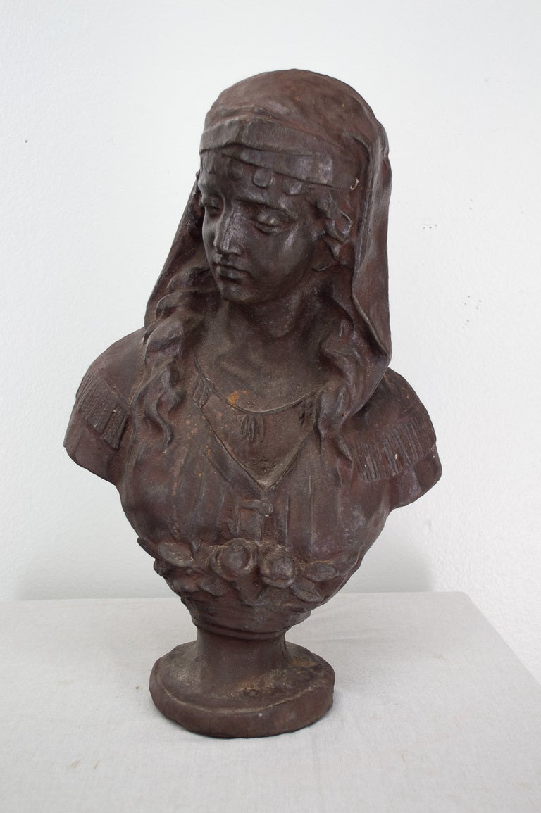 A good cast iron sculpture of the bust and head of a woman.