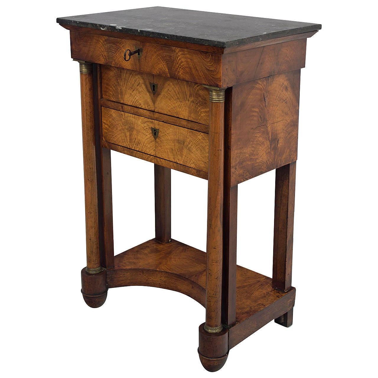 19th century French Empire period walnut side table or nightstand. Bookmatched veneer finished on all four sides. Two dovetailed drawers beneath a hinged marble top opening to reveal small compartments. Beautiful solid walnut columns with bronze