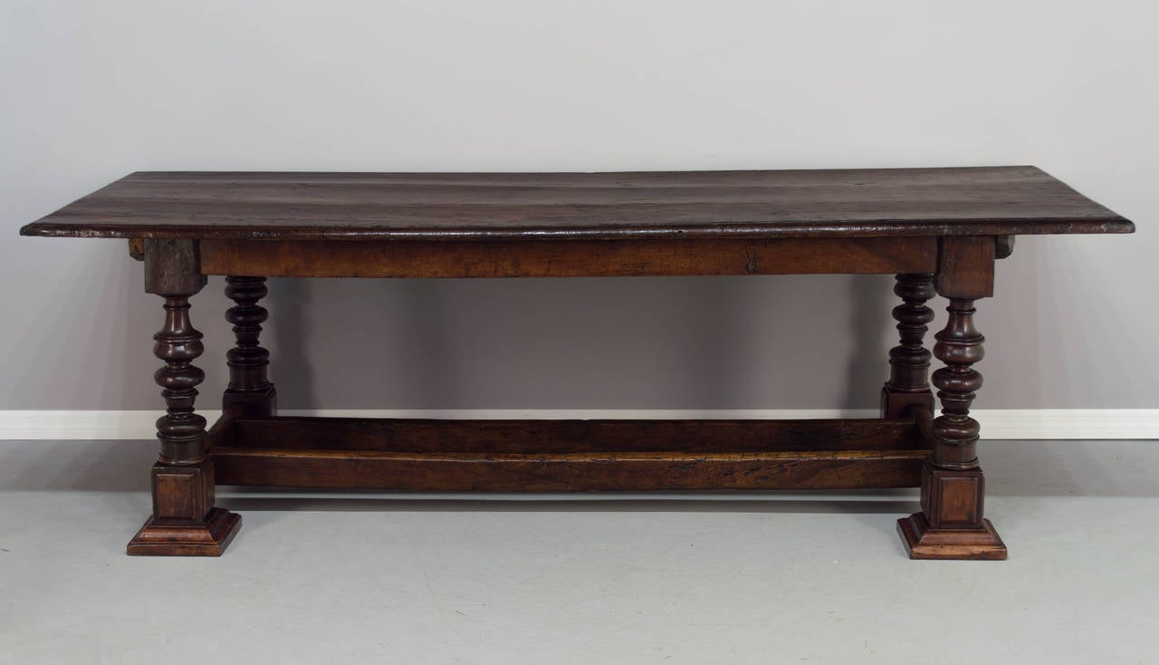 18th century French refractory or monastery table. The top is made of three heavy, solid walnut planks that are 1-1/4